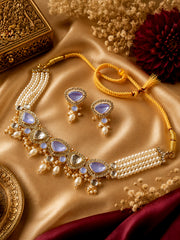 MoRa Dream lavender teardrop stone necklace and matching earrings with gold-tone detailing and pearl embellishments on a golden satin background.